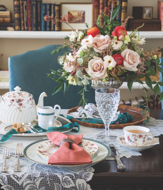 Teal, pink, and white tablescape in a library