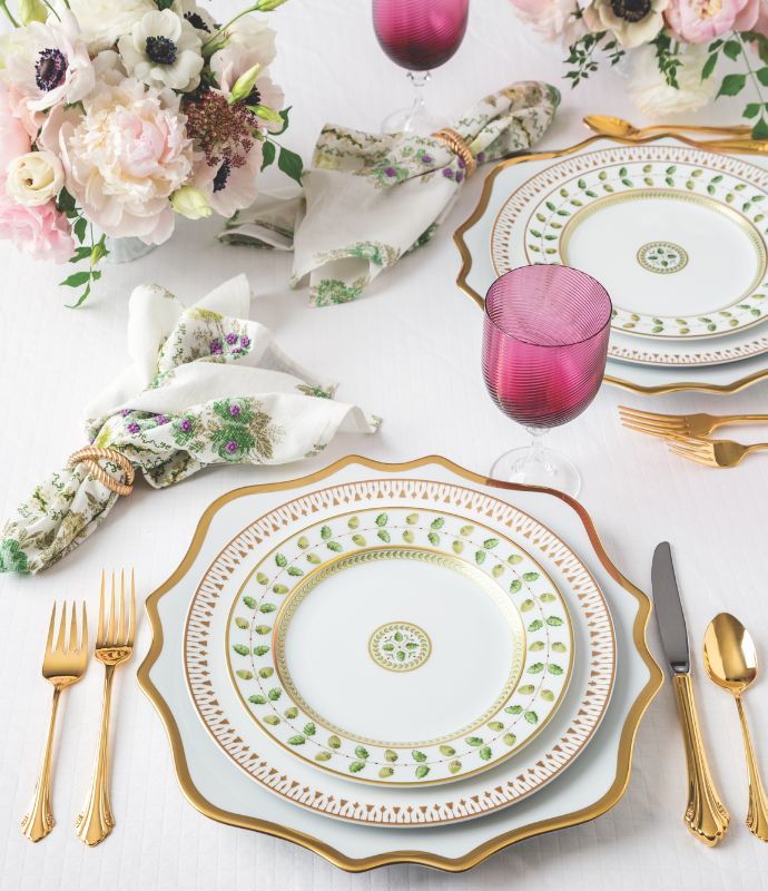 White, green, and gold place settings