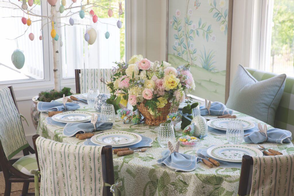 Easter tablescape with hanging Easter eggs and a basket of flowers