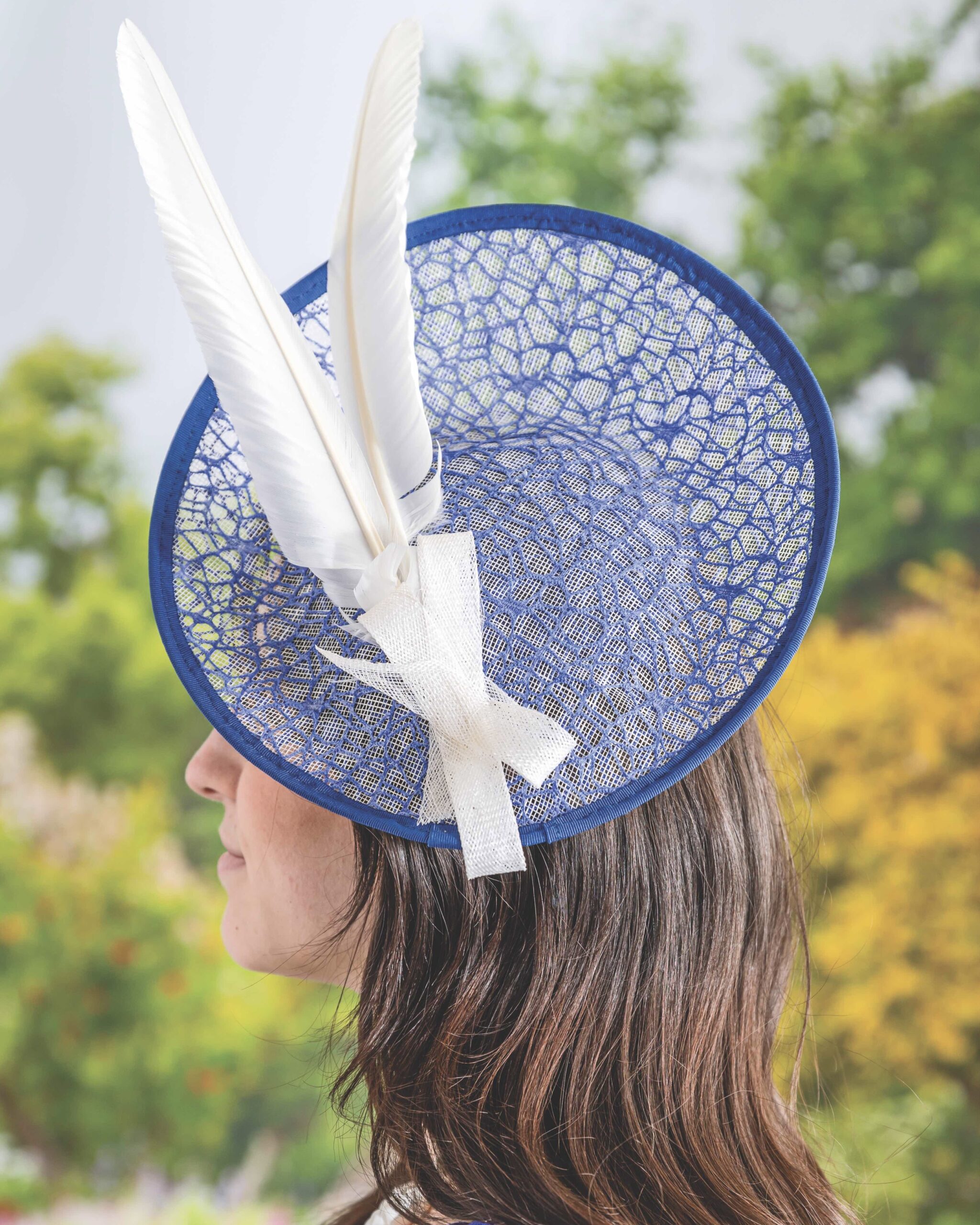 Polly Singer blue mesh fascinator with white feathers
