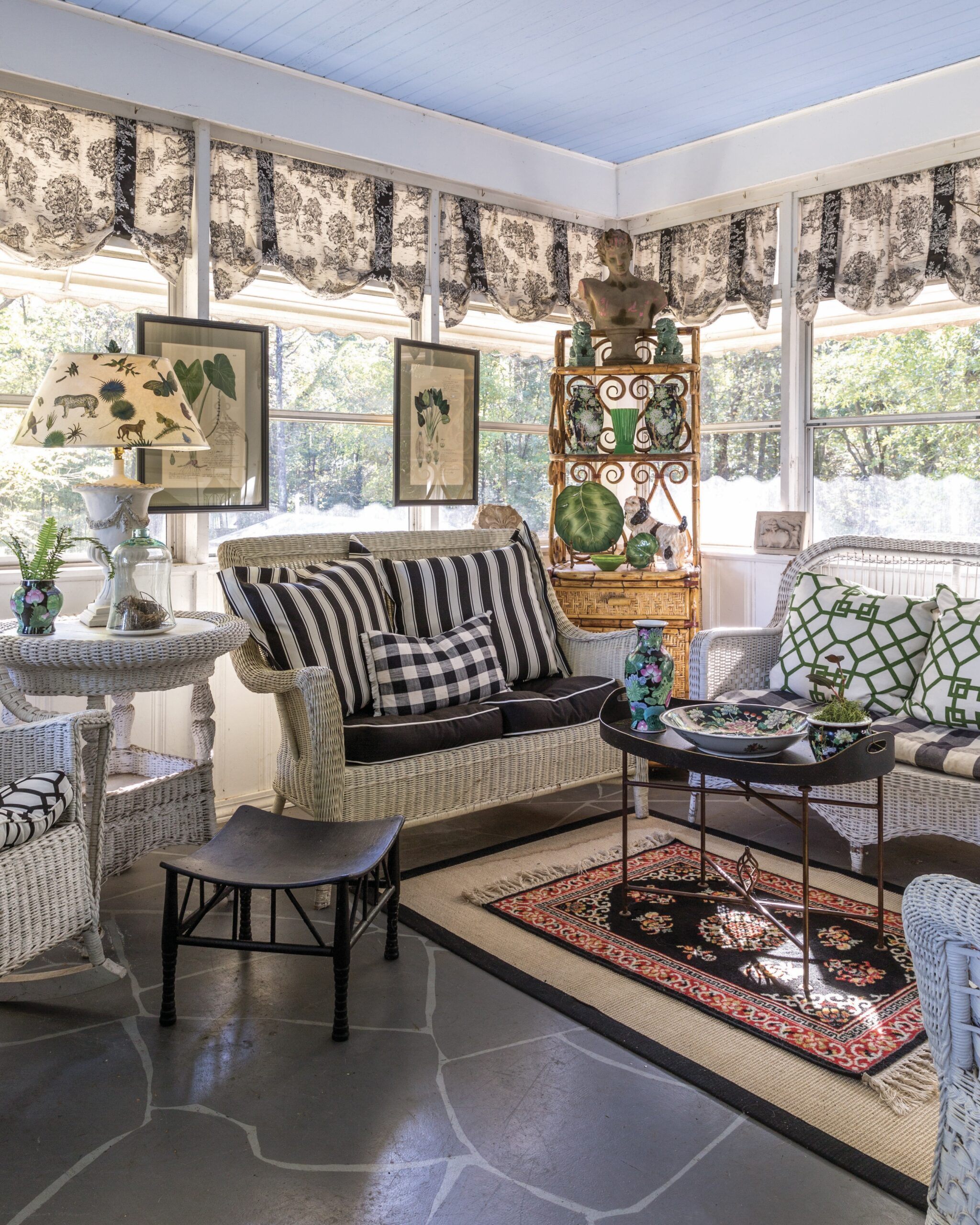 A sunroom featuring mixed patterns and china