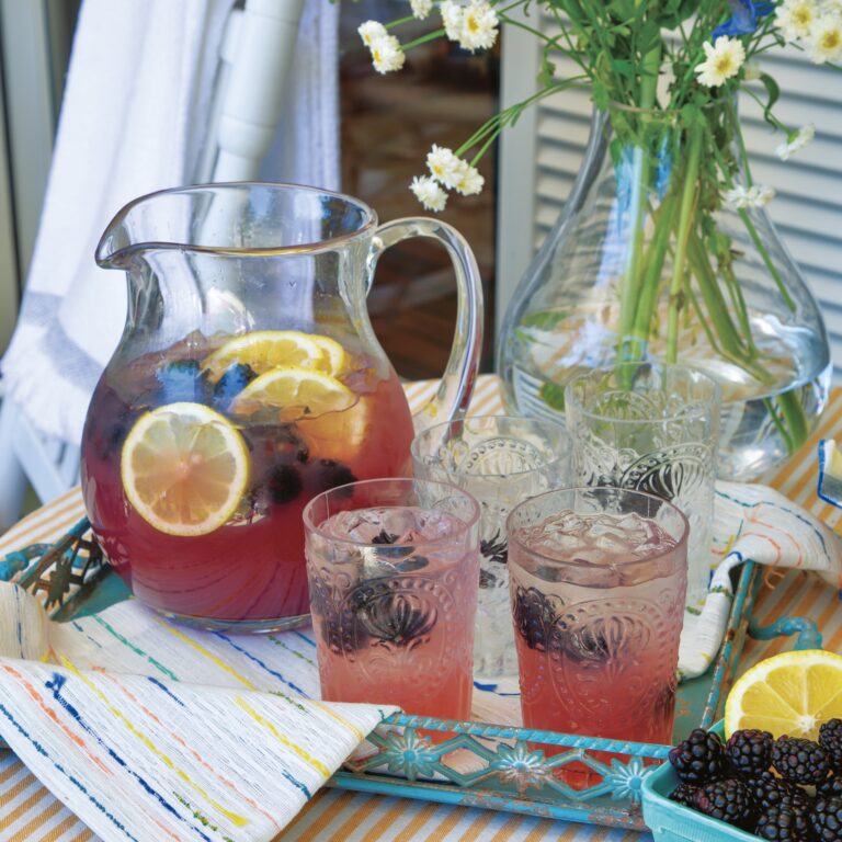 Blackberry-Ginger Lemonade in a pitcher and glasses