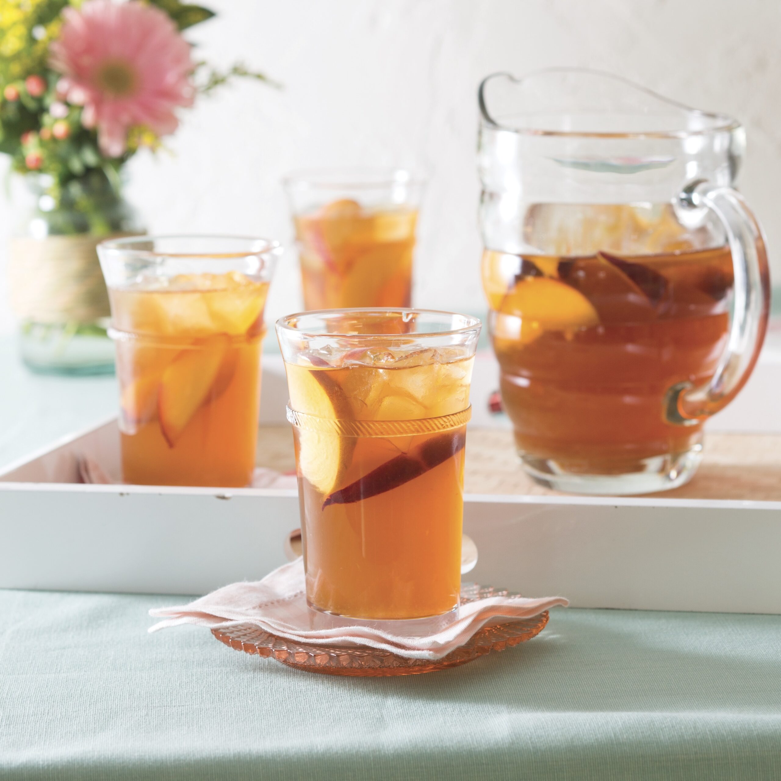 Sweet tea in a pitcher and 3 glasses