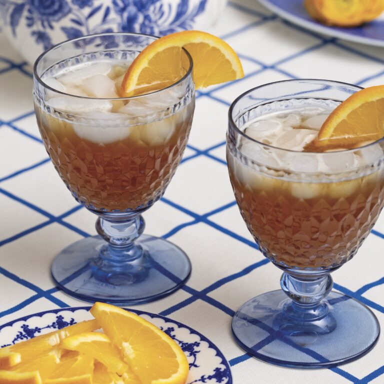 Orange iced tea in blue water goblets