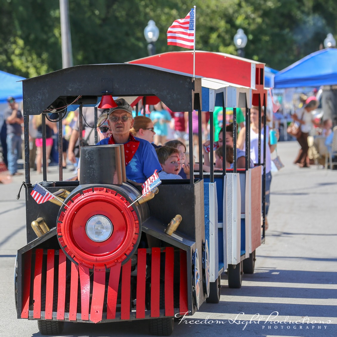 A man drives a train ride for children at Depot Days Festival in Hartselle, Alabama.
