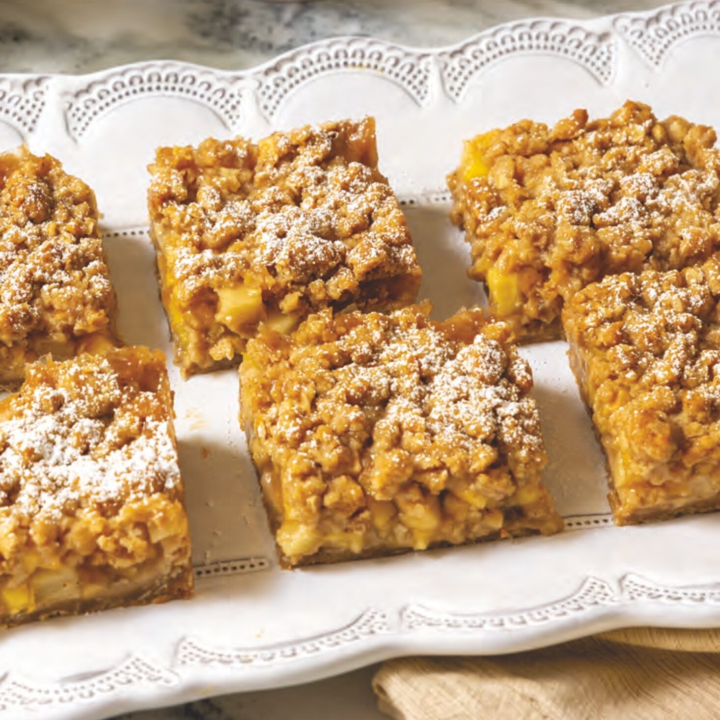 Apple-Pear Cobbler Bars sliced into squares and displayed on a platter.