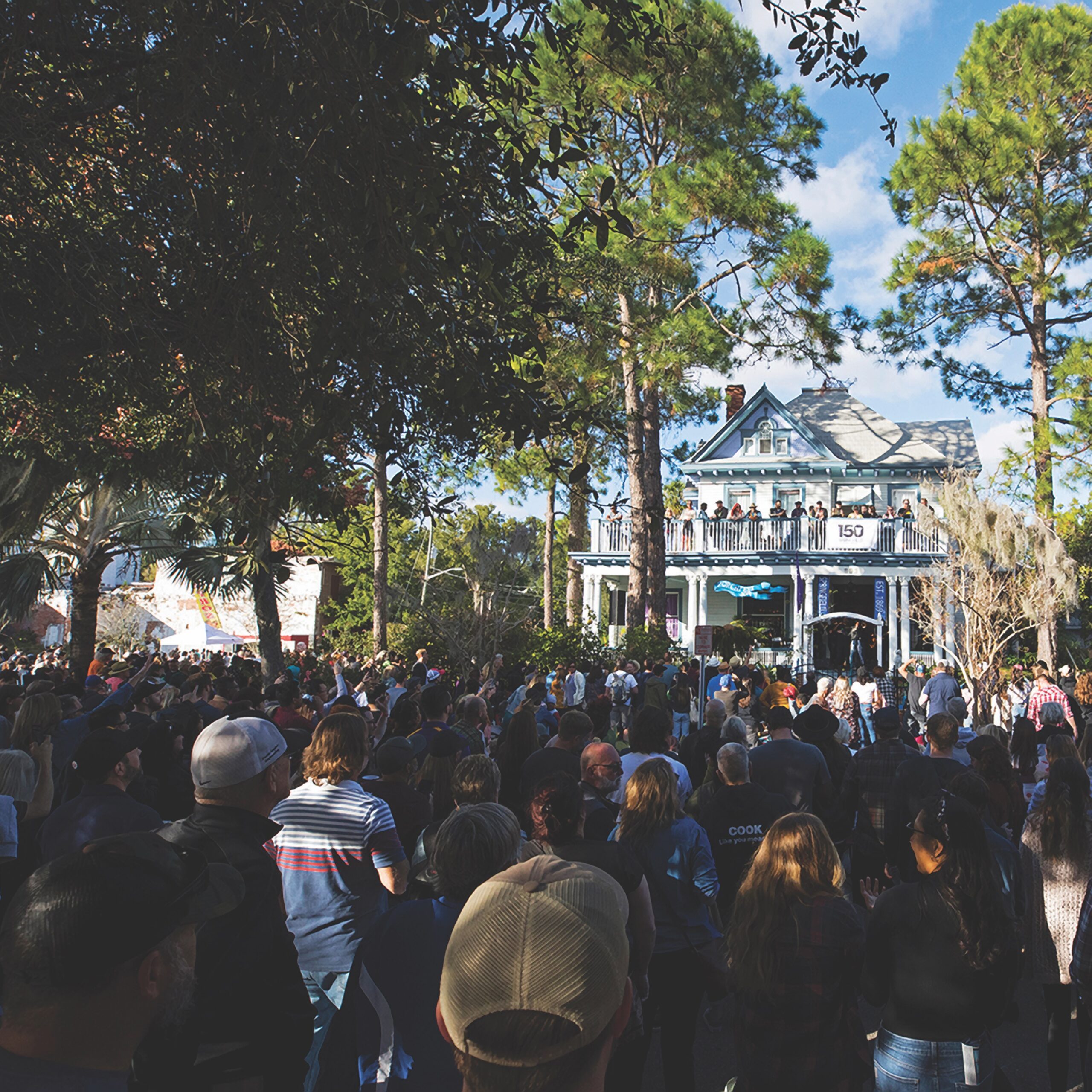 Visitors enjoy an outdoor concert on the porch of an antebellum home at Jacksonville Florida's PorchFest.