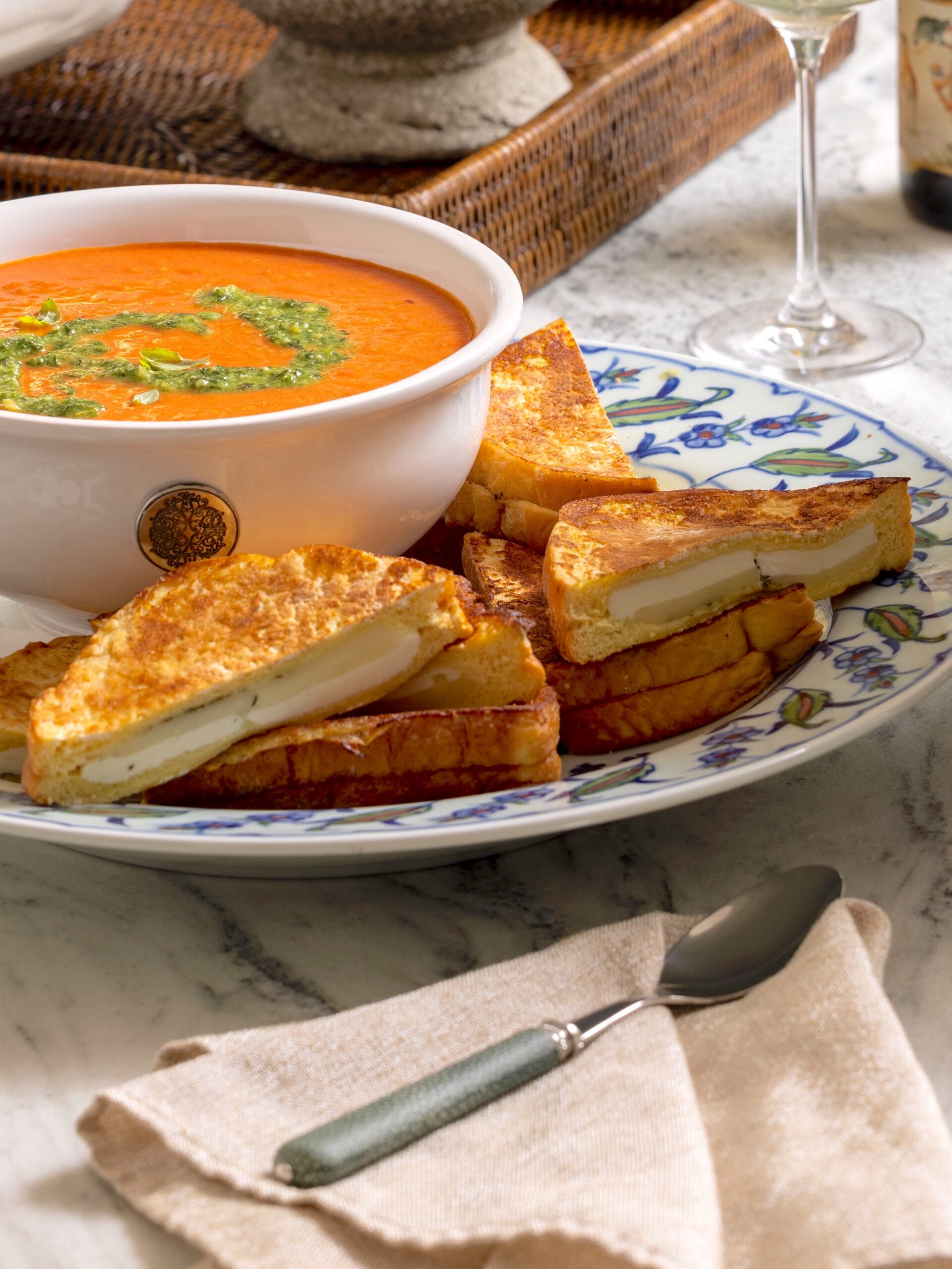 Grilled Mozzarella Cheese Toast on a plate with tomato soup.