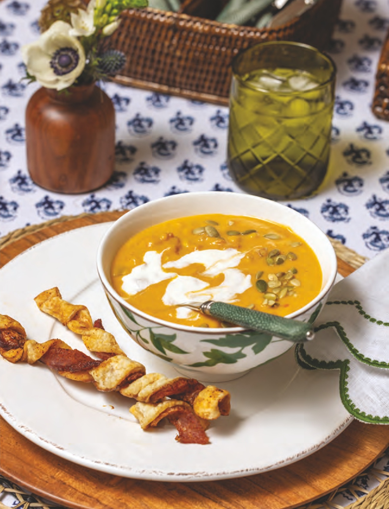 Southwest Pumpkin Soup garnished witg cilantro and creme fraiche, with Twisted Bacon Breadsticks.