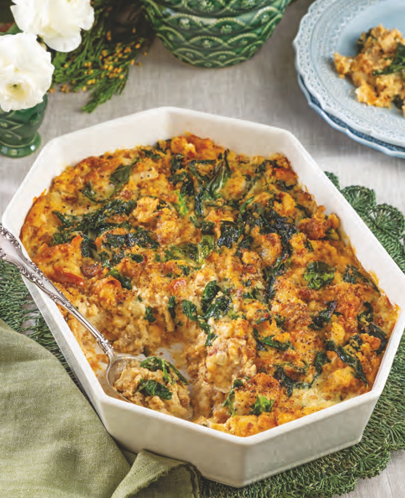 Cornbread Dressing with Sausage and Collard Greens in a casserole dish.
