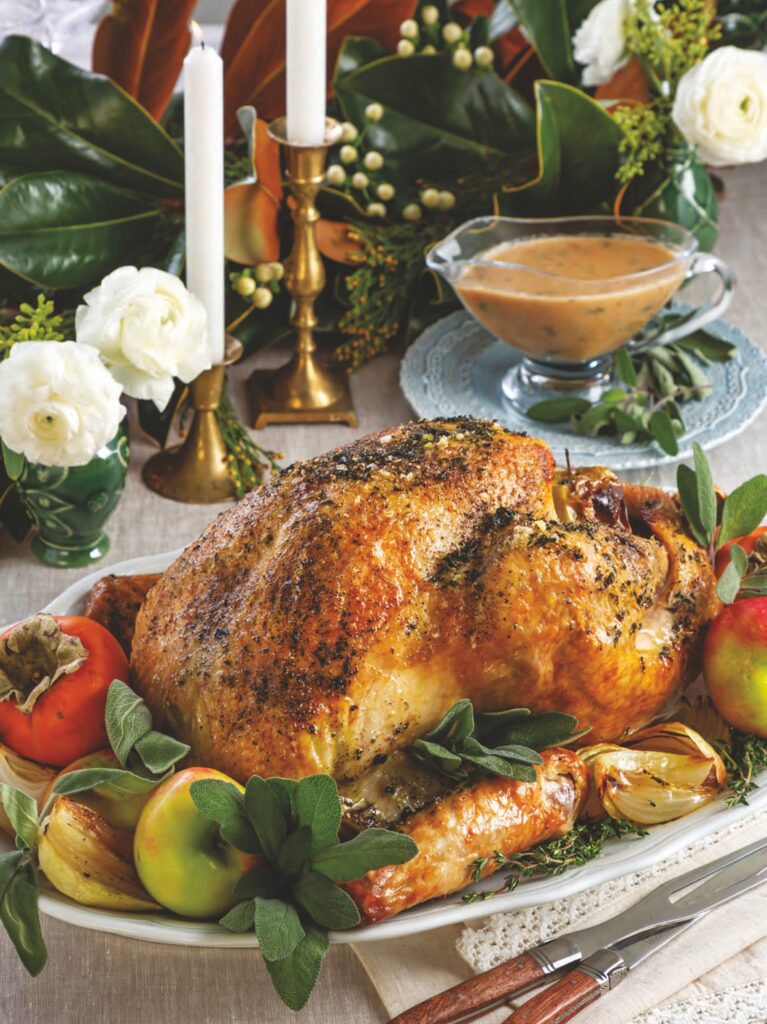 Herb Dry-Brined Turkey with Apples on a platter.