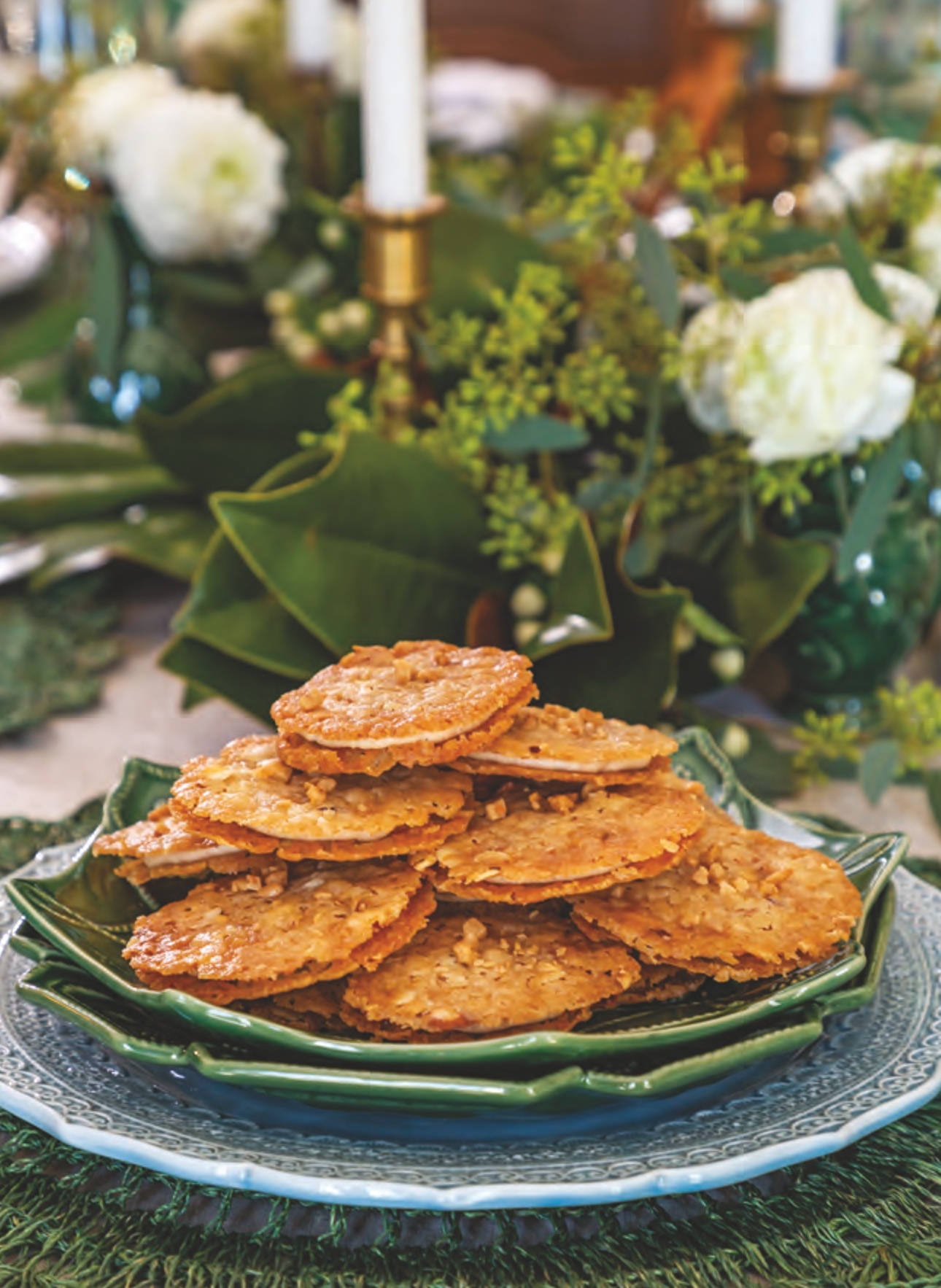 Almond-Toffee Florentine cookies stacked on a plate.

