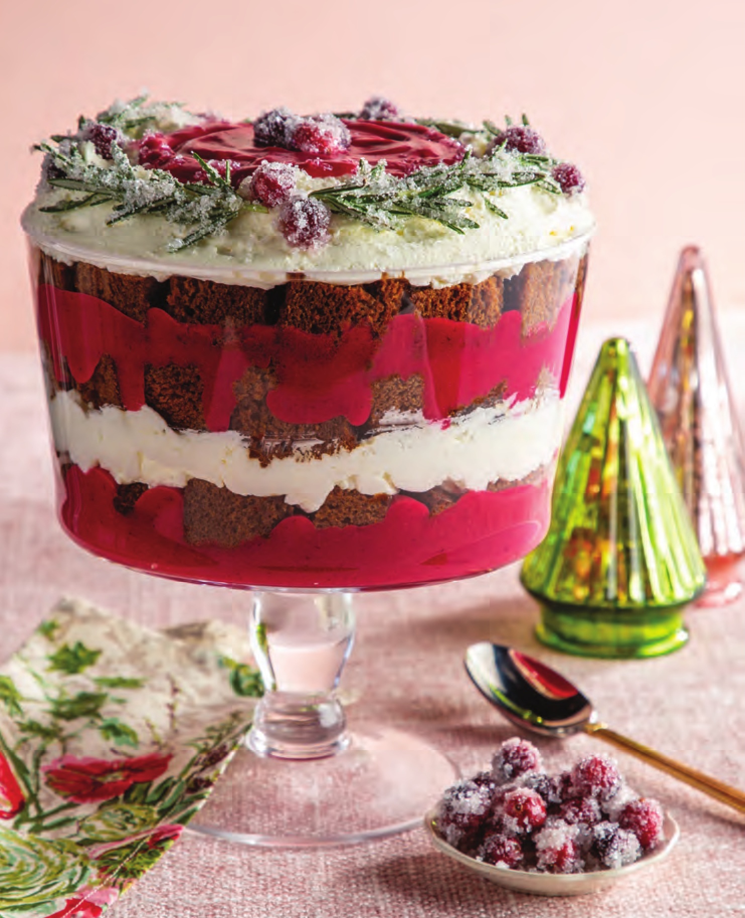 Gingerbread and Cranberry Curd Trifle in a glass dish topped with sugared rosemary and cranberries.