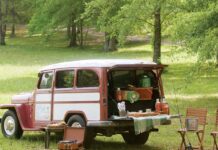 Our Favorite Football Season Finds and Tailgating Essentials A vintage station wagon with the tailgate down, filled with supplies ofr a picnic, near folding chairs and a record player outdoors.