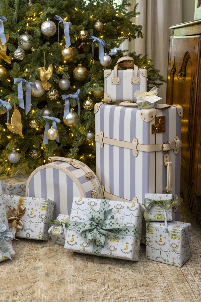 Gifts and luggage under a Christmas tree