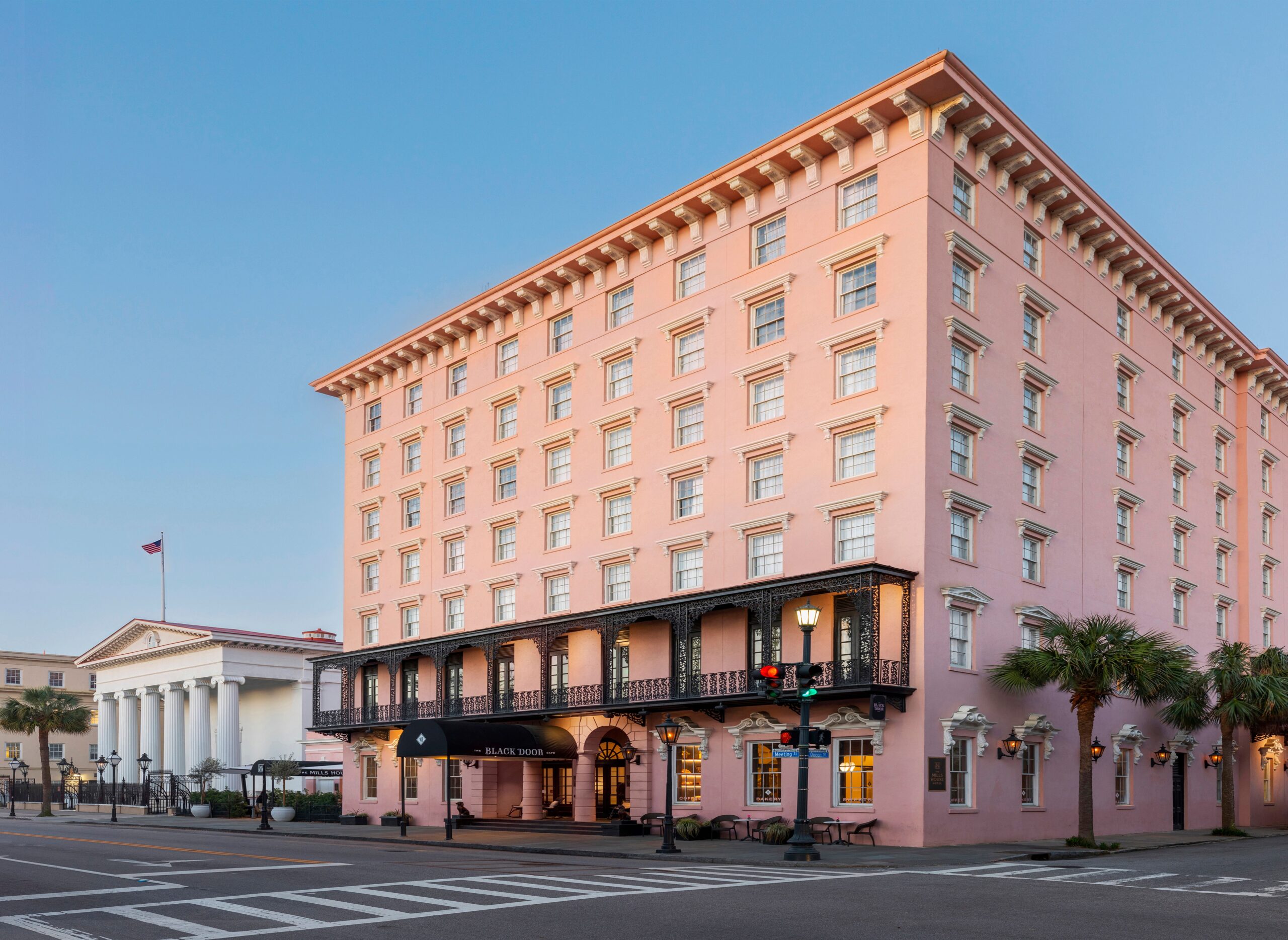 The pink exterior and wrought iron balcony of the Mills House hotel in Charleston.