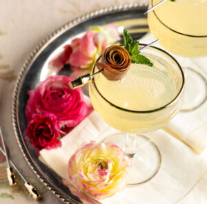 Elderflower Mimosas garnished with roses made from pear slices.