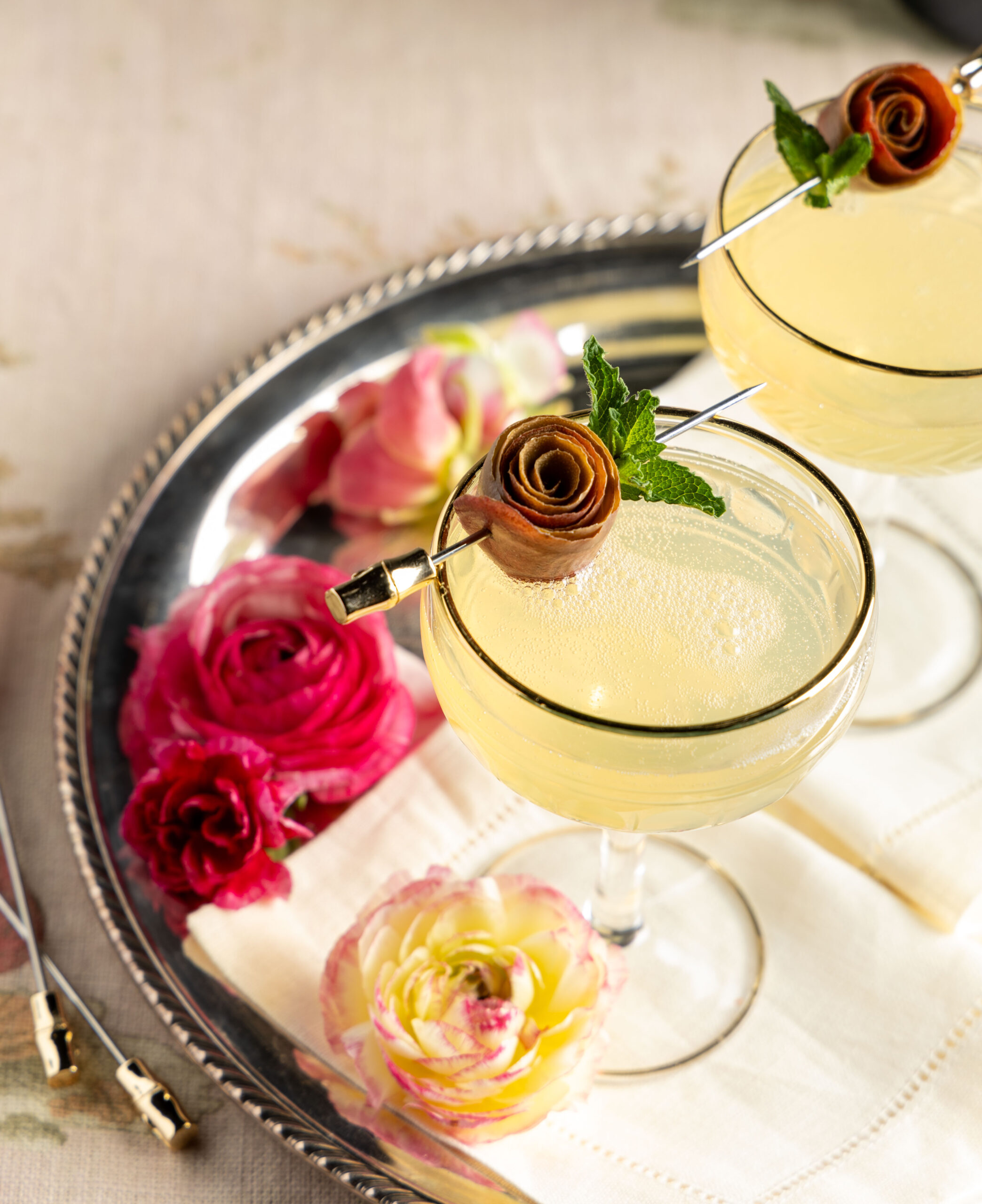 Elderflower Mimosas garnished with roses made from pear slices.