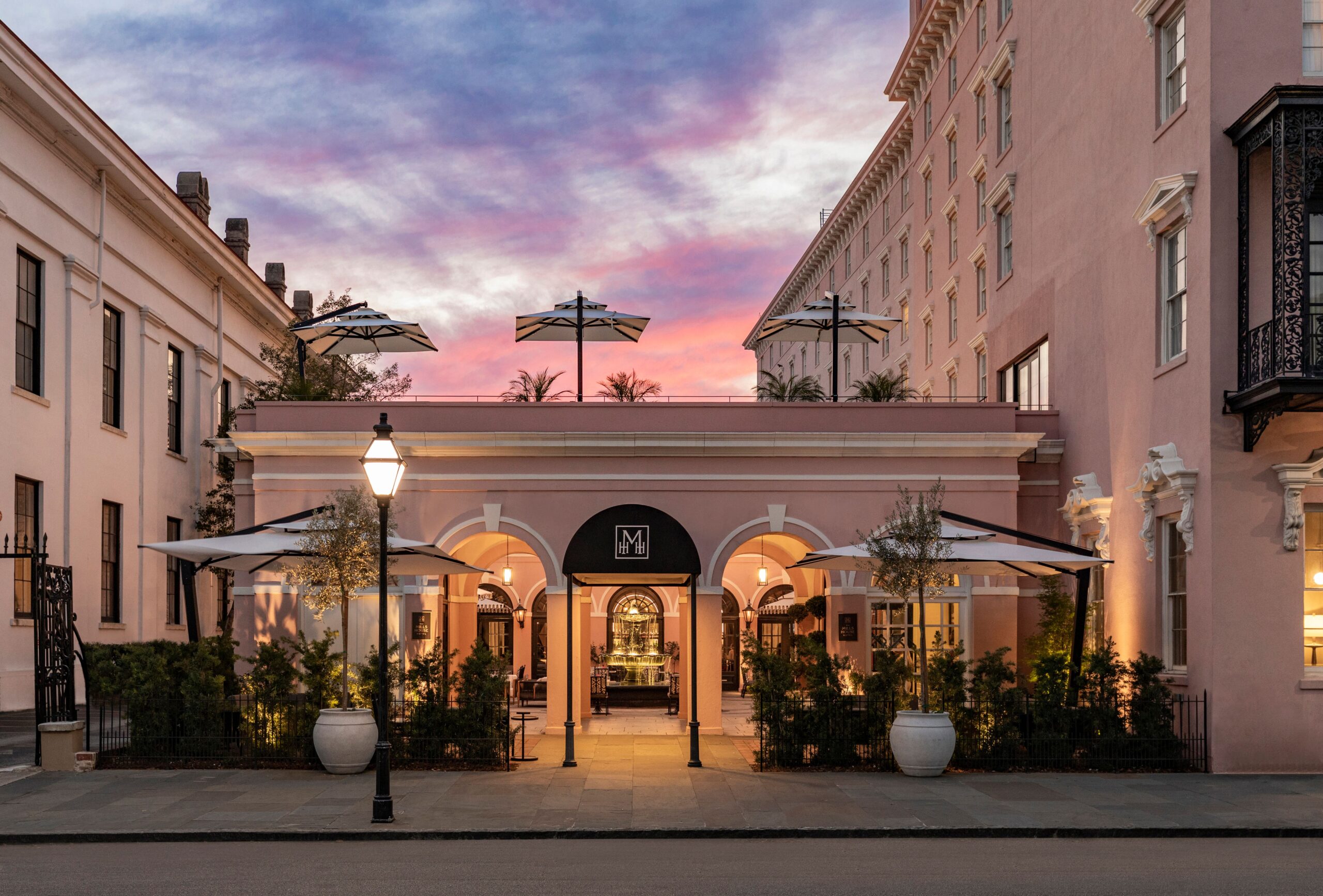 The entryway to the MIlls House hotel in Charleston at sunset.