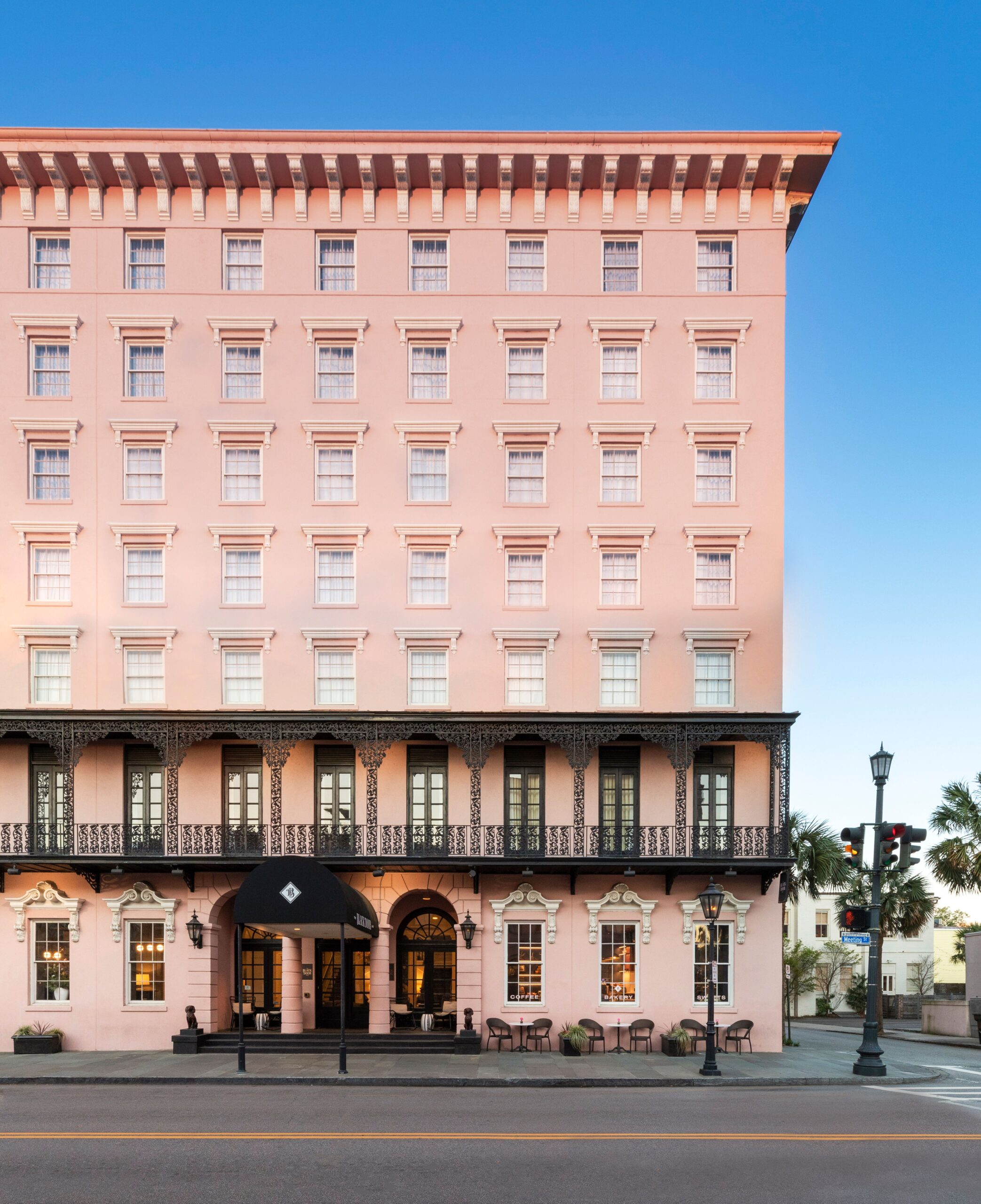 The pink exterior and cast iron balconies of Charleston's Mills House hotel.