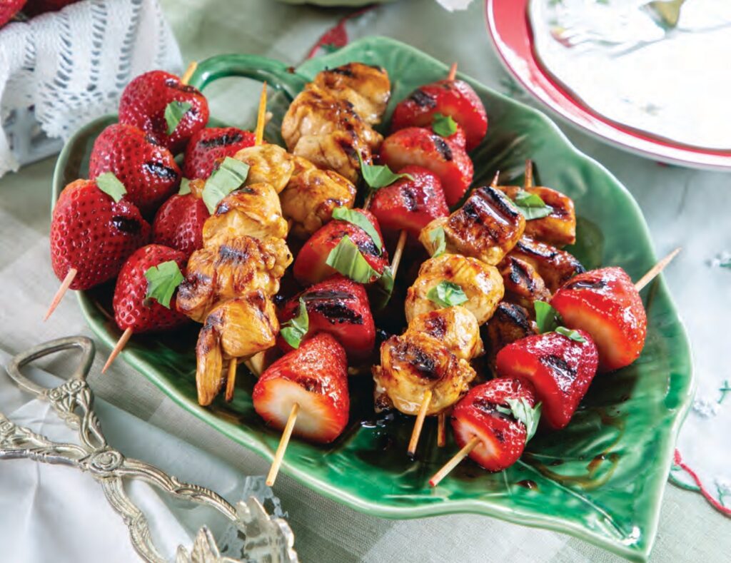 Grilled Balsamic Strawberry and Chicken Kabobs on a leaf-shaped platter.