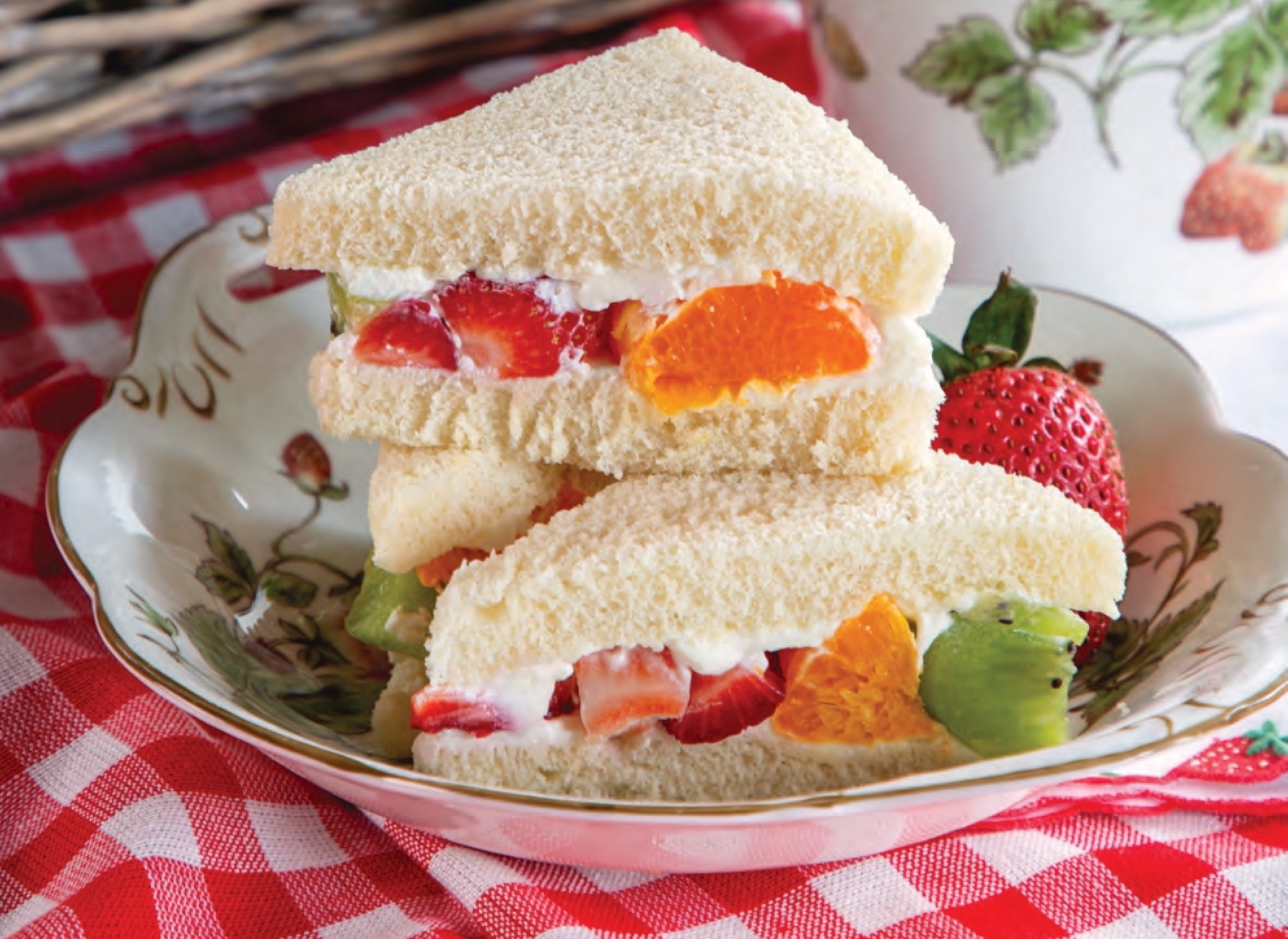 Strawberry, Kiwifruit, and Clementine Finger Sandwiches in a bowl.