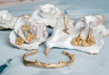 Two Southern Artists Collaborate on a Perfect Mother’s Day Collection Gold jewelry pieces displayed on oyster shells from Mary Frances Maker, designed by Charissa Owens Art.