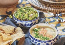 Roasted Green Chile Queso Bowls of guacamole and queso dip with tortilla chips
