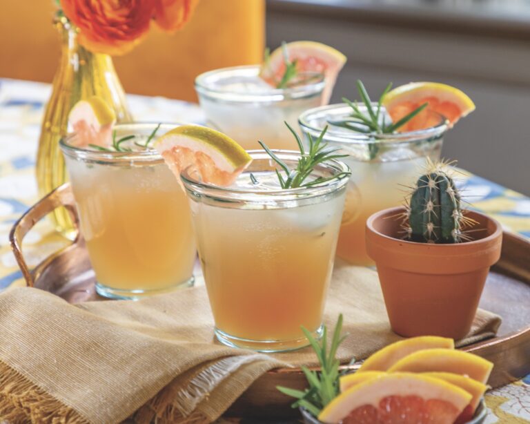 Classic Paloma cocktail garnished with rosemary
