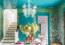 Discover Palm Beach Style in Our July/August 2025 Issue! Table with florals and decorations in a room with blue patterned wallpaper