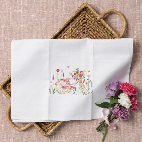 White tea towel with pink embroidered bicycle