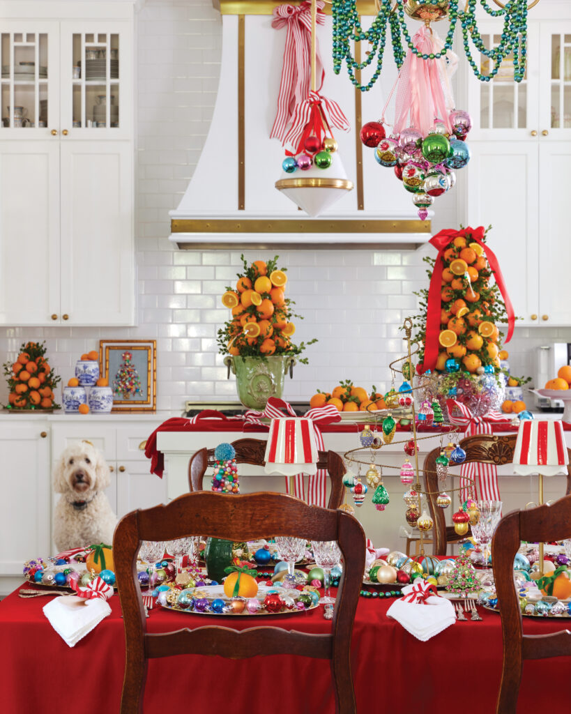 Vibrant Christmas tablescape with topiaries in the background