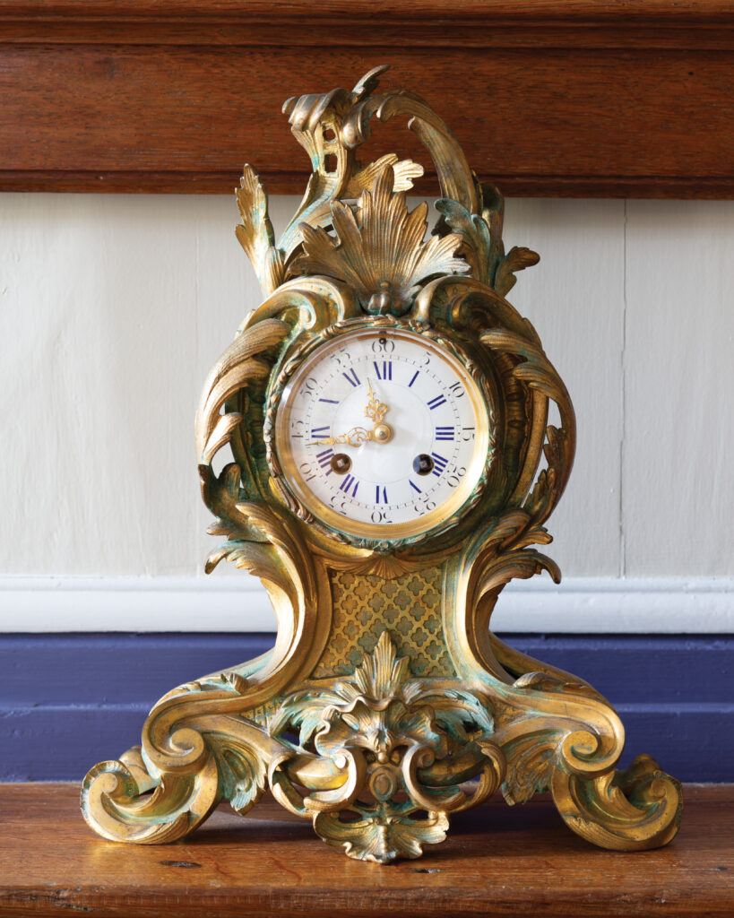 Ornate bronze clock with ribboned design 