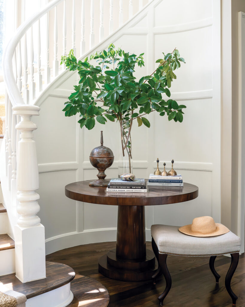 Greenery in vase on table in stairwell nook