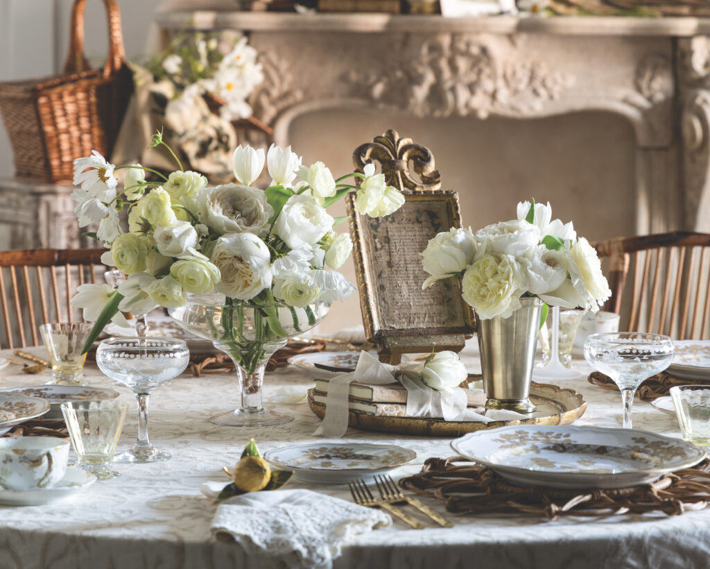 A tablescape with two white floral arrangements.