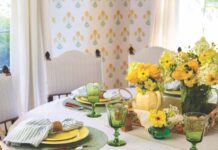 5 Recipes for a Season to Savor A circle table with several place settings with a couple of yellow floral arrangements in the center.