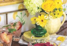 Roasted Beet Hummus Tray Roasted beet hummus in a clear bowl with various vegetables and crostini served around it on a gold platter.