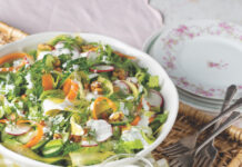 Spring Salad with Lemon-Dill Buttermilk Dressing A woven tray holding a small pitcher of ranch and a white bowl with salad.