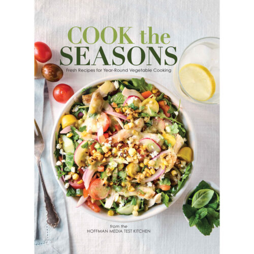 Cook the Seasons cookbook cover featuring a colorful vegetable salad in a bowl on a light table