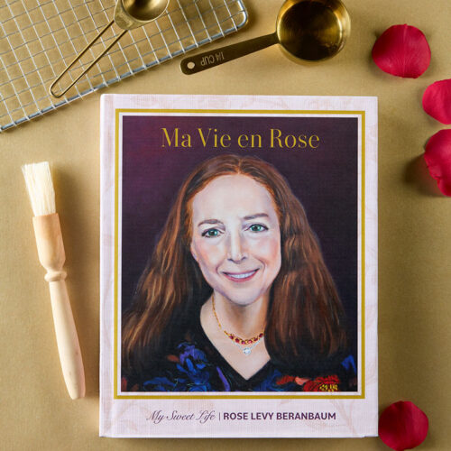 Cover of the cookbook 'Ma Vie en Rose' by Rose Levy Beranbaum, showing a painted portrait of a smiling woman with brown hair inside a gold-framed border.