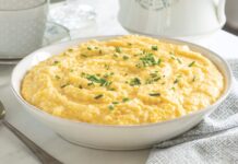 Double Cheese Grits Double Cheese Grits served in a white bowl topped with chives.