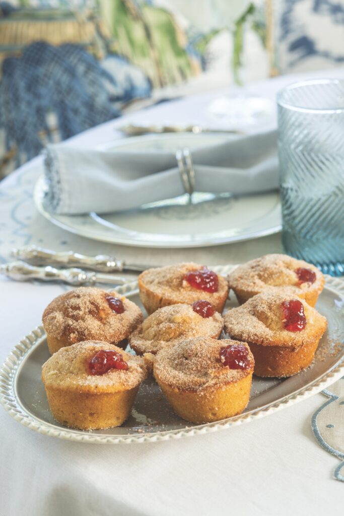 Strawberry Jelly Doughnut Muffins in a blue platter set at the dinner table.