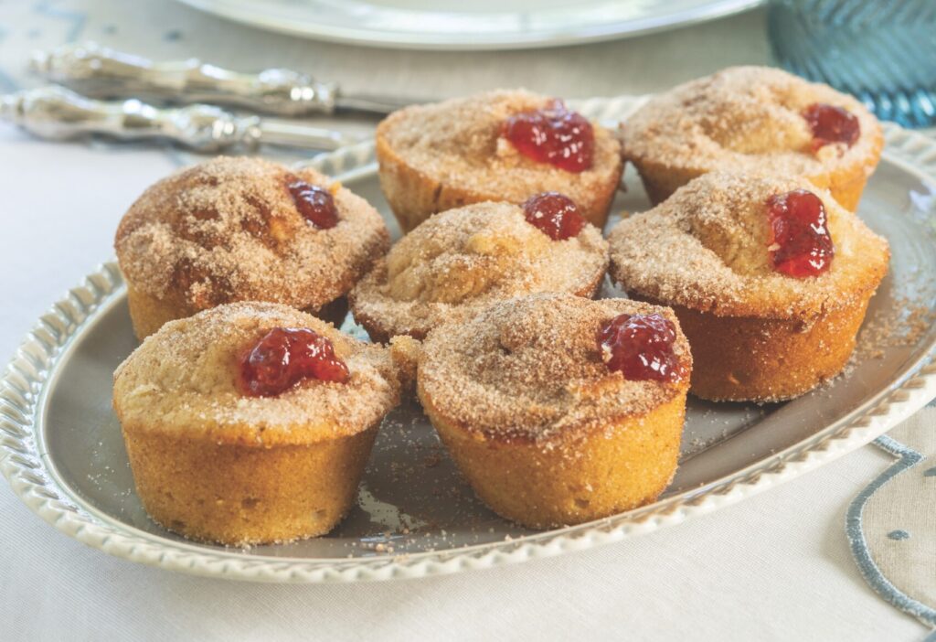 Strawberry Jelly Doughnut Muffins in a blue platter set at the dinner table.