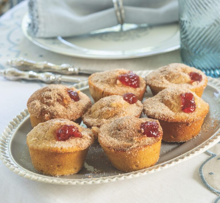 Strawberry Jelly Doughnut Muffins in a blue platter set at the dinner table.