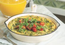 Arugula and Tomato Frittata Arugula and Tomato Frittata in a cast iron skillet, with a pitcher of orange juice.