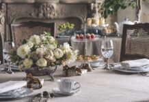 Celebrate Wedded Bliss: Preview Our May/June 2026 Issue A table set for teatime with a white floral arrangement in the center.