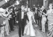 Wedding Bells Ring for these Mississippi Nuptuals A bride and groom walk through a tunnel of sparklers as they exit their wedding.