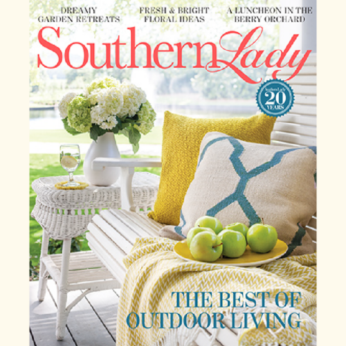 Cover of Southern Lady magazine showing a sunlit porch scene: white wicker chair with yellow and teal pillows, a plate of green apples, a vase of white hydrangeas, and the headline 'The Best of Outdoor Living'