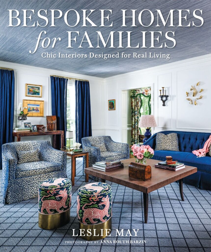 The cover of Bespoke Homes for Families by Leslie May, showing a blue-and-white living room with tufted sofa and leopard-print chairs